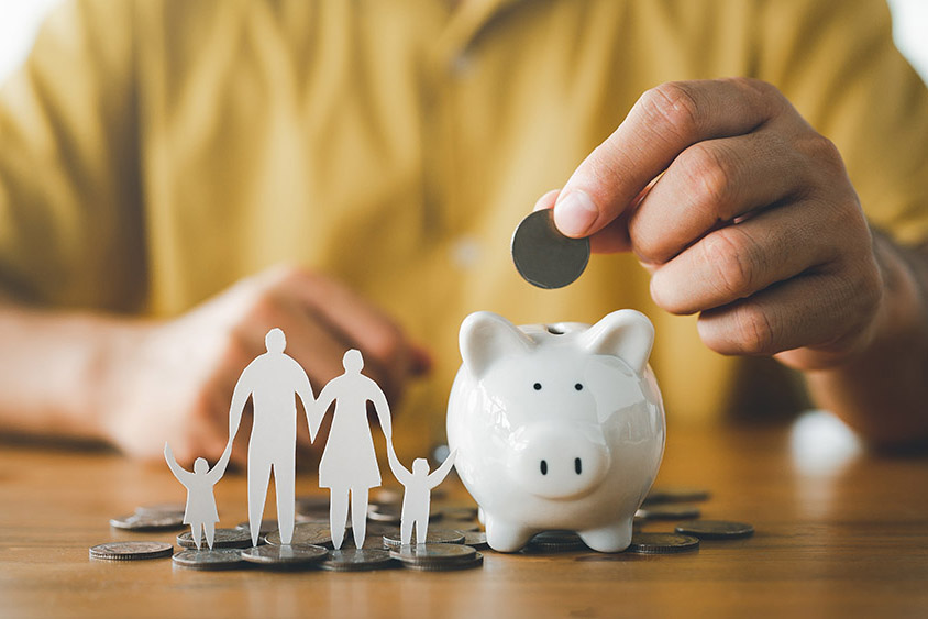 Man putting coin on the piggybank